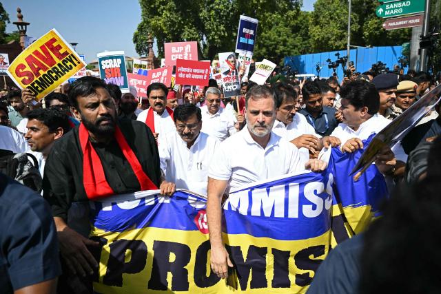 Indian National Congress (INC) party leader Rahul Gandhi (centre R) takes part in a protest march by the opposition alliance INDIA bloc (Indian National Developmental Inclusive Alliance) in New Delhi on October 6, 2026, against the country's Chief Election Commissioner Gyanesh Kumar calling for his resignation over alleged irregularities in the Special Intensive Revision (SIR) of electoral rolls. (Photo by Arun SANKAR / AFP)