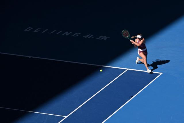 Russia's Ekaterina Alexandrova hits a return to Czech Republic's Linda Noskova during their women's singles match at the China Open tennis tournament in Beijing on October 6, 2026. (Photo by Adek BERRY / AFP)