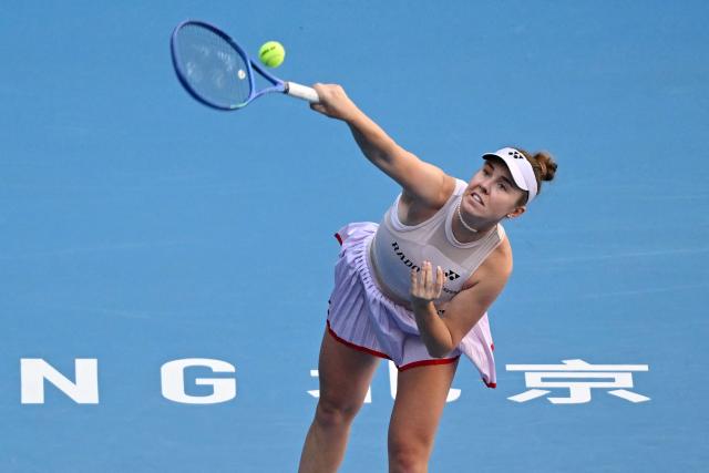 Czech Republic's Linda Noskova serves to Russia's Ekaterina Alexandrova during their women's singles match at the China Open tennis tournament in Beijing on October 6, 2026. (Photo by Adek BERRY / AFP)