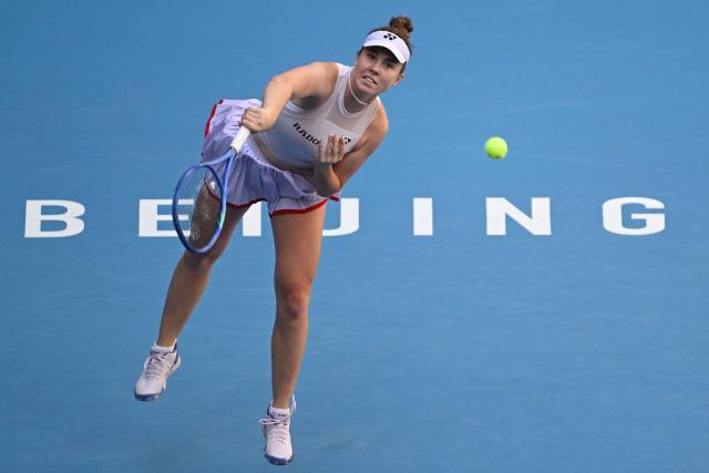 Czech Republic's Linda Noskova serves to Russia's Ekaterina Alexandrova during their women's singles match at the China Open tennis tournament in Beijing on October 6, 2026. (Photo by Adek BERRY / AFP)