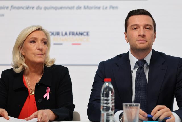 Far-right party Rassemblement National (RN) candidate in France's 2027 presidential election Marine Le Pen (L) and President of French far-right party Rassemblement National (RN) Jordan Bardella attend a press conference to present the party’s counter-budget for 2027 and its proposed budgetary trajectory for 2027–2032 at the party's headquarters in Paris, on October 6, 2026. (Photo by MEHDI FEDOUACH / AFP)