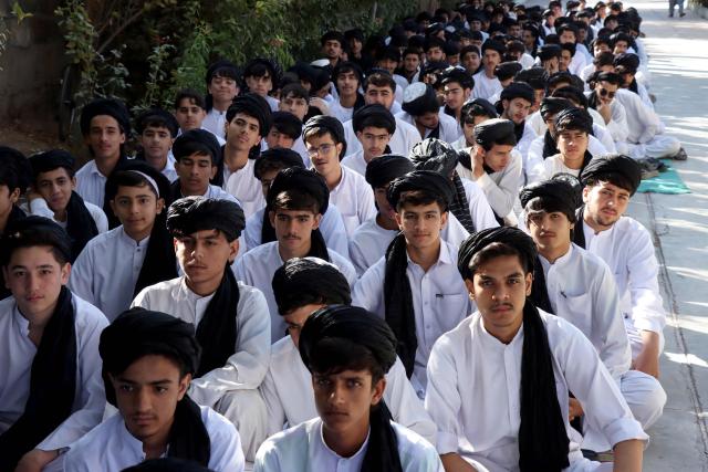 Afghan high school students sit in the courtyard before their class at a school in Afghanistan's Herat province on October 6, 2026. (Photo by Mohsen KARIMI / AFP)