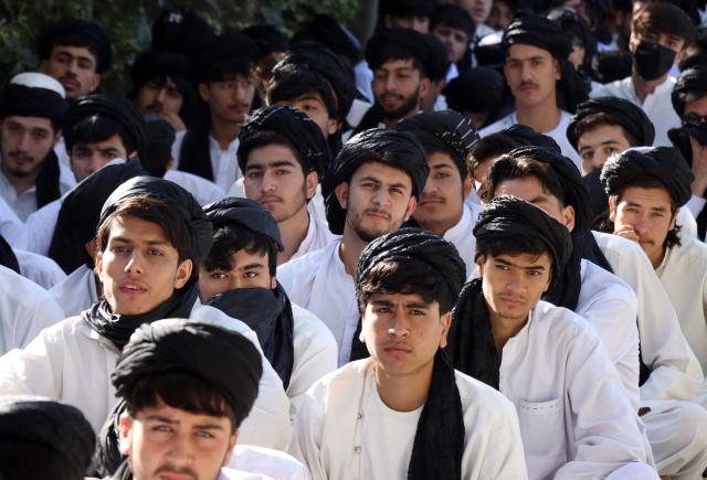 Afghan high school students sit in the courtyard before their class at a school in Afghanistan's Herat province on October 6, 2026. (Photo by Mohsen KARIMI / AFP)