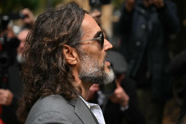 British comedian and actor Russell Brand arrives at Southwark Crown Court in south London on October 6, 2026, to attend a pre-trial hearing after pleading not guilty to three charges of rape, indecent assault, and three counts of sexual assault (Photo by JUSTIN TALLIS / AFP)