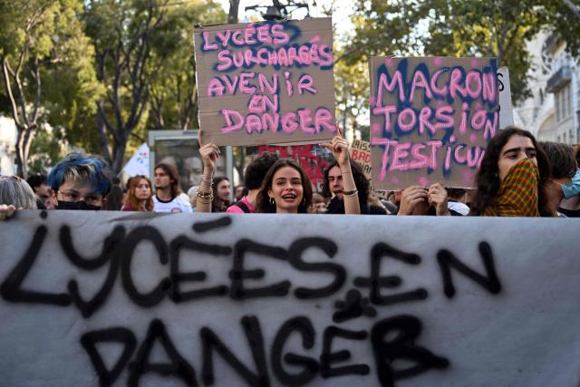 Students hold a banner reading "High-school students in danger" and a placard reading "Overcrowded high schools, future in danger" during a demonstration of high-school students as part of a nationwide protest movement over learning conditions in Marseille, south-eastern France, on October 6, 2026. Since late September, pupils have barred the entrances to hundreds of schools, complaining of teacher absences, overloaded timetables, dilapidated classrooms and buildings ill-adapted to rising temperatures, among other grievances. (Photo by Miguel MEDINA / AFP)