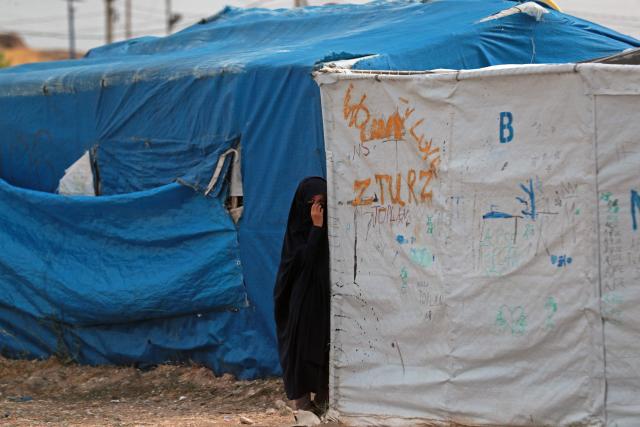 A girl stands outside her tent at the Roj detention camp built for relatives of suspected jihadists, in the northeast of Syria on October 5, 2026. (Photo by Delil SOULEIMAN / AFP)