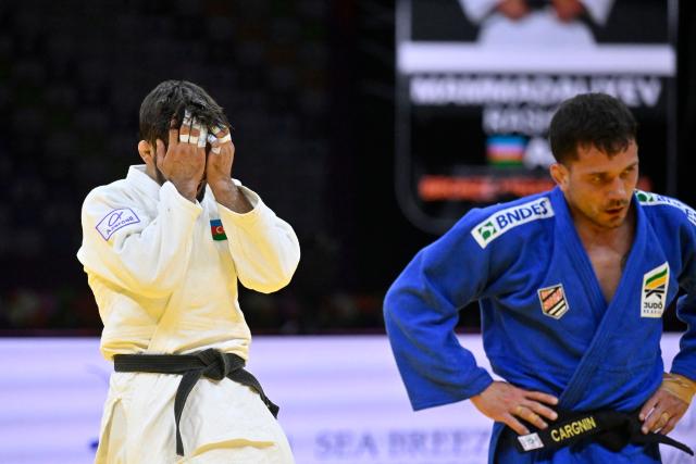 Azerbaijan's Rashid Mammadaliyev (white) reacts after defeating Brazil's Daniel Cargnin in the men's under 73 kg category bronze medal bout at the World Judo Championships in Baku on October 6, 2026 (Photo by Alexander NEMENOV / AFP)