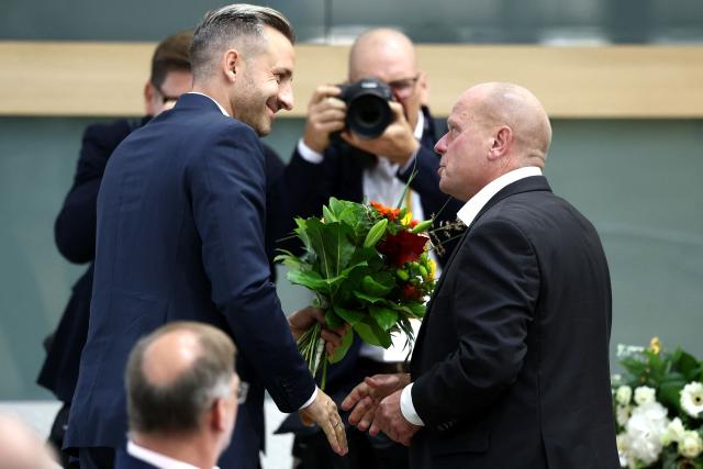 Ulrich Siegmund of the far-right Alternative for Germany (AfD) party congratulates newly elected vice president of the state parliament Carsten Borchert of the Christian Democratic Union (CDU) during the first constituent session of the state parliament of Saxony-Anhalt in Magdeburg, eastern Germany, on October 6, 2026. The AfD became Germany's first far-right party to win the post of speaker in a state parliament since World War II, when its candidate was elected in an eastern region. The Alternative for Germany (AfD) took nearly 44 percent of the September 2026 vote in Saxony Anhalt state in the former communist East Germany, easily beating the centre-right CDU of unpopular Chancellor Friedrich Merz. (Photo by Jan Woitas / POOL / AFP)
