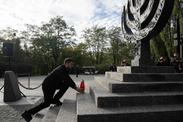 President of Ukraine Volodymyr Zelensky takes part in a memorial ceremony at the Babyn Yar National Historical and Memorial Reserve to honor the victims of the mass execution of civilians by the Nazis during World War II, in Kyiv on October 6, 2026, amid the Russian invasion of Ukraine. (Photo by Genya SAVILOV / AFP)
