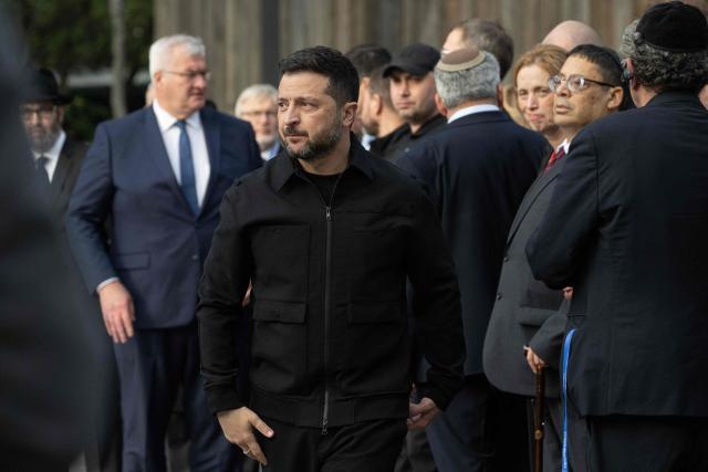 President of Ukraine Volodymyr Zelensky looks on during a memorial ceremony at the Babyn Yar National Historical and Memorial Reserve to honor the victims of the mass execution of civilians by the Nazis during World War II, in Kyiv on October 6, 2026, amid the Russian invasion of Ukraine. (Photo by Genya SAVILOV / AFP)