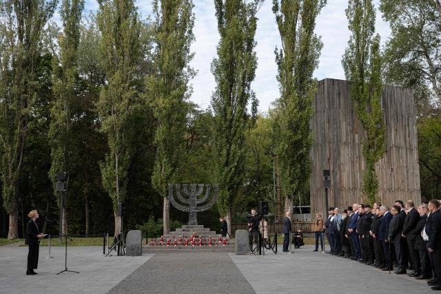 Federal Minister of Education, Family, Senior Citizens, Women and Youth of Germany Karin Prien (L) delivers a speech during a memorial ceremony at the Babyn Yar National Historical and Memorial Reserve to honor the victims of the mass execution of civilians by the Nazis during World War II, in Kyiv on October 6, 2026, amid the Russian invasion of Ukraine. (Photo by Genya SAVILOV / AFP)
