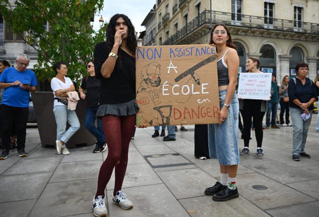 People hold a placard reading in French "failure to assist school in danger" during a demonstration part of a nationwide day of actions called by high-school students, joined by unions and teachers, who for days have been demanding better learning conditions in protests punctuated by violent confrontations in Bayonne, southwestern France, on October 6, 2026. Students have blocked the entrances to hundreds of high schools for 15- to 17-year-olds since late September, complaining of missing teachers, overloaded timetables, dilapidated classrooms and buildings that cannot cope with rising temperatures. (Photo by Gaizka IROZ / AFP)