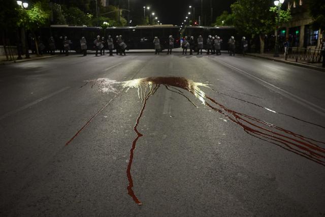 A red paint thrown by protesters is seen on the road outside the Greek Parliament during a demonstration against the official visit of US Secretary of State Marco Rubio to Athens, on October 6, 2026. More than 2,000 protesters, according to the police, gathered in central Athens on Tuesday evening to protest against the visit of U.S. Secretary of State Marco Rubio to Greece. (Photo by Aris MESSINIS / AFP)