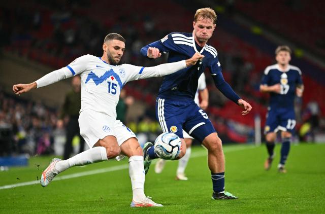Slovenia's forward #15 Danijel Sturm (L) clears from Scotland's defender #05 Stephen Welsh during the UEFA Nations League, League B, Group 1 football match between Scotland and Slovenia at Hampden Park in Glasgow, Scotland on October 6, 2026.  (Photo by ANDY BUCHANAN / AFP)