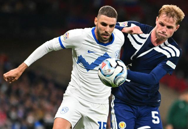 Scotland's defender #05 Stephen Welsh (R) vies with Slovenia's forward #15 Danijel Sturm during the UEFA Nations League, League B, Group 1 football match between Scotland and Slovenia at Hampden Park in Glasgow, Scotland on October 6, 2026.  (Photo by ANDY BUCHANAN / AFP)