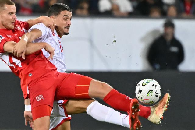 Switzerland's defender #4 Nico Elvedi (L) and North Macedonia's forward #11 Elmin Rastoder (R) fight for the ball during the UEFA Nations League Group B1 football match between Switzerland and North Macedonia at the Thermoplan Arena in Lucerne on October 6, 2026. (Photo by Fabrice COFFRINI / AFP)
