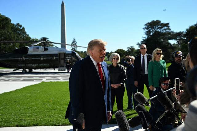 US President Donald Trump speaks to the press before walking to board Marine One on the South Lawn of the White House in Washington, DC, on October 6, 2026. President Trump is traveling to Sparrows Point, Maryland where he will speak at Anduril Industries. (Photo by Alex WROBLEWSKI / AFP)