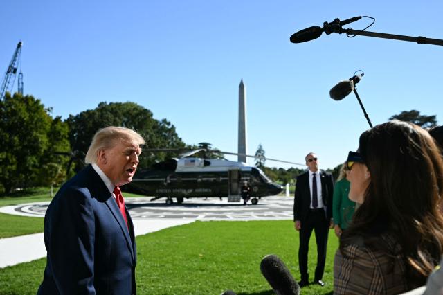 US President Donald Trump speaks to the press before boarding Marine One on the South Lawn of the White House in Washington, DC, on October 6, 2026. Trump is traveling to Sparrows Point, Maryland, where he will speak at Anduril Industries. (Photo by Alex WROBLEWSKI / AFP)