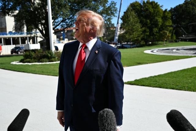 US President Donald Trump speaks to the press before walking to board Marine One on the South Lawn of the White House in Washington, DC, on October 6, 2026. President Trump is traveling to Sparrows Point, Maryland where he will speak at Anduril Industries. (Photo by Alex WROBLEWSKI / AFP)