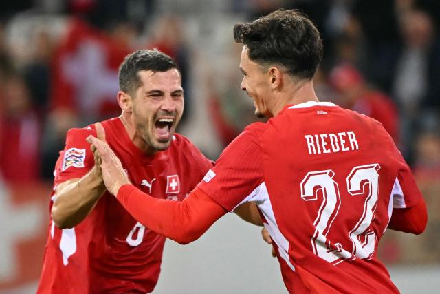 Switzerland's midfielder #22 Fabian Rieder (R) celebrates with Switzerland's defender #18 Eray Comert (L) after scoring Switzerland's first goal during the UEFA Nations League Group B1 football match between Switzerland and North Macedonia at the Thermoplan Arena in Lucerne on October 6, 2026. (Photo by Fabrice COFFRINI / AFP)
