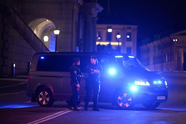 Female police officers stand next to a police vehicle after police shot a man acting out armed with a knife, near the Royal Palace in central Stockholm, Sweden, on October 6, 2026. Swedish police said on October 6 they shot an armed man outside the Royal Palace in central Stockholm after receiving reports of a disruptive individual carrying a weapon. Police said officers responding to the incident opened fire on the man. "The man was hit and taken to hospital," a Stockholm police spokeswoman told AFP. She said his injuries were considered serious but not life-threatening. (Photo by Jessica GOW / TT News Agency / AFP) / Sweden OUT