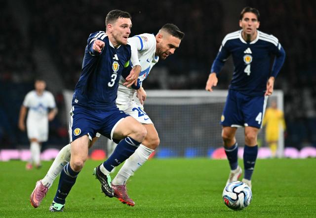 Scotland's defender #03 Andrew Robertson (L) holds off a challenge from Slovenia's forward #20 Aljosa Matko during the UEFA Nations League, League B, Group 1 football match between Scotland and Slovenia at Hampden Park in Glasgow, Scotland on October 6, 2026.  (Photo by ANDY BUCHANAN / AFP)