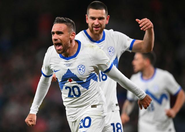 Slovenia's forward #20 Aljosa Matko (L) celebrates after scoring the equalising goal during the UEFA Nations League, League B, Group 1 football match between Scotland and Slovenia at Hampden Park in Glasgow, Scotland on October 6, 2026.  (Photo by ANDY BUCHANAN / AFP)