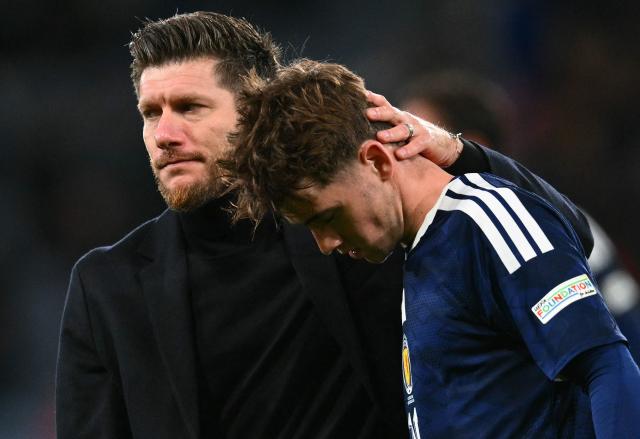 TOPSHOT - Scotland's Belgian head coach Sebastien Pocognoli commiserates Scotland's midfielder #16 Findlay Curtis after the UEFA Nations League, League B, Group 1 football match between Scotland and Slovenia at Hampden Park in Glasgow, Scotland on October 6, 2026. Slovenia won the match 2-1. (Photo by ANDY BUCHANAN / AFP)