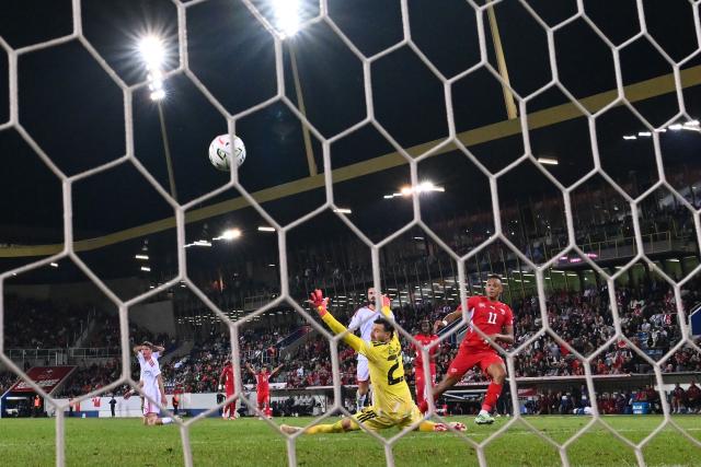 North Macedonia's goalkeeper #23 Stole Dimitrievski (C) watches as the ball hits the back of the net as Switzerland's forward #11 Dan Ndoye (R) scores Switzerland's second goal during the UEFA Nations League Group B1 football match between Switzerland and North Macedonia at the Thermoplan Arena in Lucerne on October 6, 2026. (Photo by Fabrice COFFRINI / AFP)