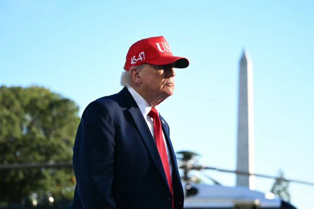 US President Donald Trump speaks to the press upon his return to the White House in Washington, DC, on October 6, 2026. President Trump is returning from Sparrows Point, Maryland, where he spoke at Anduril Industries. (Photo by Alex WROBLEWSKI / AFP)