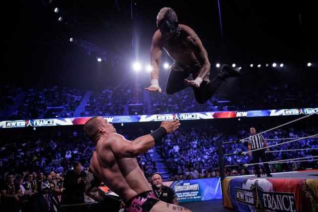 Wrestler Darby Allin (R) jumps on wrestler Kyle Fletcher (L) during the AEW Grand Slam event at the Adidas Arena in Paris on October 6, 2026. (Photo by Simon WOHLFAHRT / AFP)