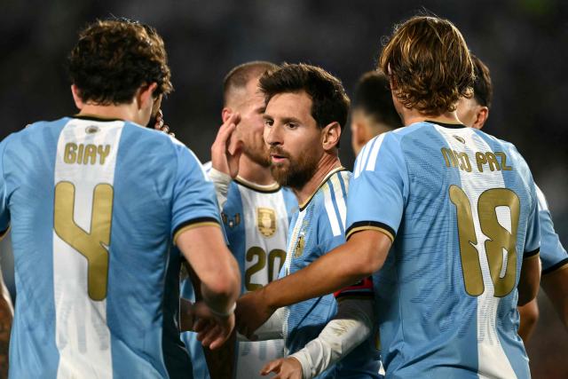 Argentina's midfielder #18 Nico Paz (R) celebrates scoring his team's second goal with teammate Argentina's forward #10 Lionel Messi during the international friendly football match between Argentina and Benin at the Mas Monumental stadium in Buenos Aires on October 6, 2026. (Photo by Luis ROBAYO / AFP)