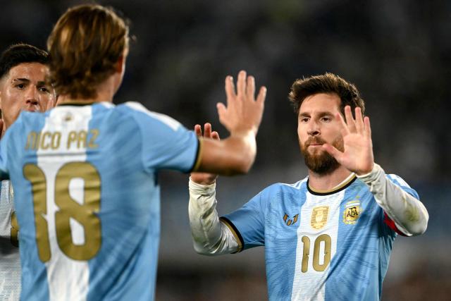 Argentina's midfielder #18 Nico Paz celebrates scoring his team's second goal with teammate Argentina's forward #10 Lionel Messi during the international friendly football match between Argentina and Benin at the Mas Monumental stadium in Buenos Aires on October 6, 2026. (Photo by Luis ROBAYO / AFP)