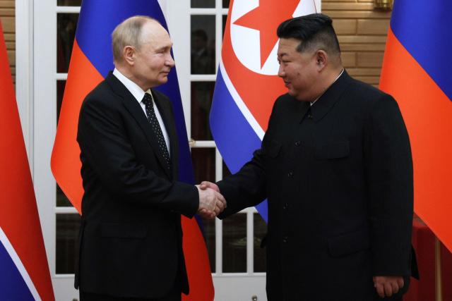 (FILES) In this pool photograph distributed by the Russian state agency Sputnik, North Korea's leader Kim Jong Un (R) and and Russian President Vladimir Putin shake hands after a welcoming ceremony at Kim Il Sung Square in Pyongyang on June 19, 2024. Kim pledged his "invariable support" for Russia in a birthday letter to Putin, while hailing Moscow's war in Ukraine as "sacred", state media reported on October 7, 2026. (Photo by Gavriil GRIGOROV / POOL / AFP) / -- Editor's note : this image is distributed by the Russian state owned agency Sputnik --