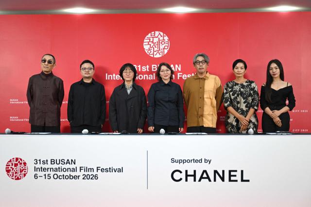 (L-R) Chinese director Zhang Yimou, Chinese director Bi Gan, South Korean director Jung Ju-ri, Kazakhstani actress Samal Yeslyamova, Japanese director Kei Ishikawa, Vietnamese producer Tran Thi Bich Ngoc and South Korean actress Choi Hee-seo pose for a photo during a press conference of the Competition Jury for the 31st Busan International Film Festival (BIFF) at the Busan Cinema Center in Busan on October 7, 2026. (Photo by Jung Yeon-je / AFP)