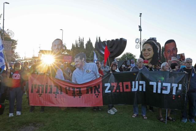 Israelis hold placards, banners and cut-outs of of victims as they gather outside the Knesset, Israel's parliament in Jerusalem on October 7, 2026, to mark the third anniversary of Hamas's October 7, 2023 attack. Israel marks the third anniversary of Hamas's October 7, 2023 attack, just weeks before an election in which the deadliest day in the country's history will be front and centre. (Photo by AHMAD GHARABLI / AFP)