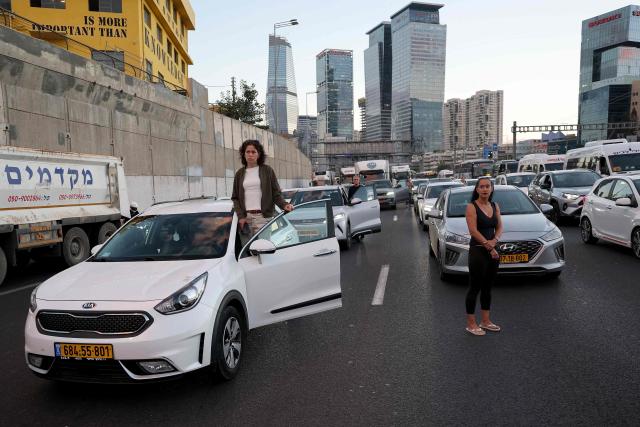 Commuters conduct a moment of silence on the highway as part of a memorial ceremony in Tel Aviv on October 7, 2026, to mark the third anniversary of Hamas's October 7 attack. Israel marked the third anniversary of Hamas's October 7 attack with silent tributes, new strikes on Gaza and intense political debate, weeks before elections in which the country's deadliest day will be front and centre. (Photo by Jack GUEZ / AFP)