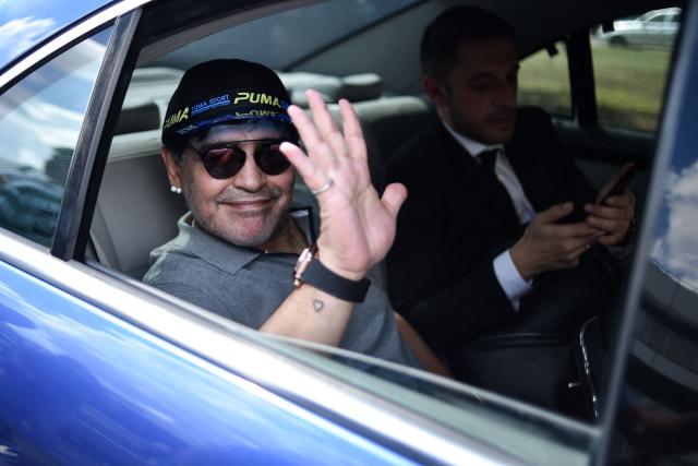 (FILES) Football star Diego Maradona waves from a car upon arrival at an airport in Brest on July 16, 2018. The trial over Diego Maradona's death enters its final stage in early October 2026 after almost six months of hearings, with the question still unresolved as to whether the football icon's death in late 2020 was unforeseeable or the result of medical negligence during his home care. (Photo by Sergei GAPON / AFP)