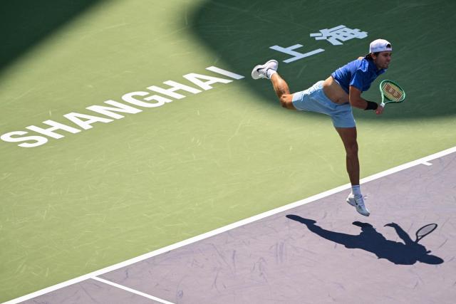 USA's Aleksandar Kovacevic serves to Italy's Matteo Berrettini during their men's singles match at the Shanghai Masters tennis tournament in Shanghai on October 7, 2026. (Photo by Hector RETAMAL / AFP)