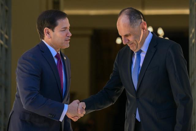 US Secretary of State Marco Rubio (L) is welcomed by Greek Foreign Minister George Gerapetritis (R) prior to their meeting at the Ministry of Foreign Affairs in Athens on October 7, 2026. (Photo by Aris MESSINIS / AFP)