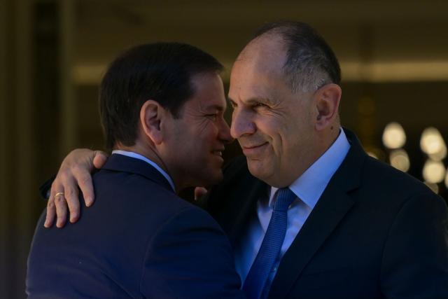 US Secretary of State Marco Rubio (L) is welcomed by Greek Foreign Minister George Gerapetritis (R) prior to their meeting at the Ministry of Foreign Affairs in Athens on October 7, 2026. (Photo by Aris MESSINIS / AFP)
