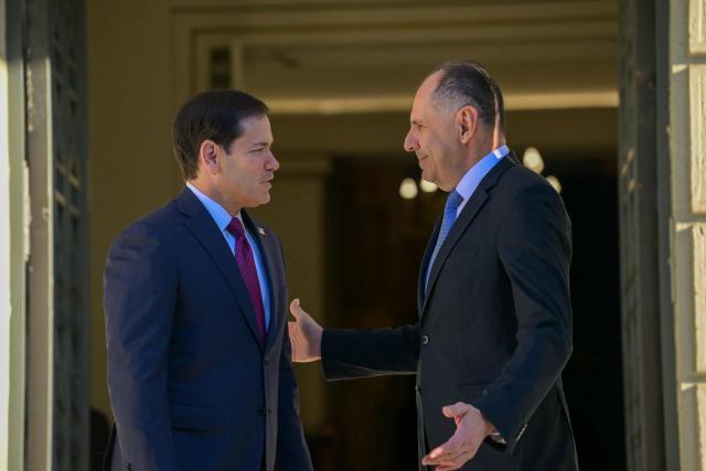 US Secretary of State Marco Rubio (L) is welcomed by Greek Foreign Minister George Gerapetritis (R) prior to their meeting at the Ministry of Foreign Affairs in Athens on October 7, 2026. (Photo by Aris MESSINIS / AFP)