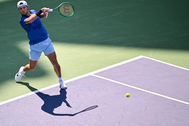 USA's Aleksandar Kovacevic hits a return to Italy's Matteo Berrettini during their men's singles match at the Shanghai Masters tennis tournament in Shanghai on October 7, 2026. (Photo by Hector RETAMAL / AFP)