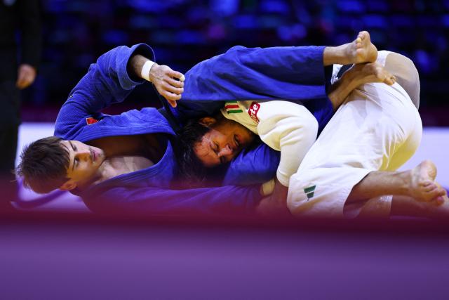 Italy's Manuel Parlati (white) competes against Moldova's Petru Pelivan in the men's under 81 kg round of 64 at the World Judo Championships in Baku on October 7, 2026. (Photo by Anne-Christine POUJOULAT / AFP)