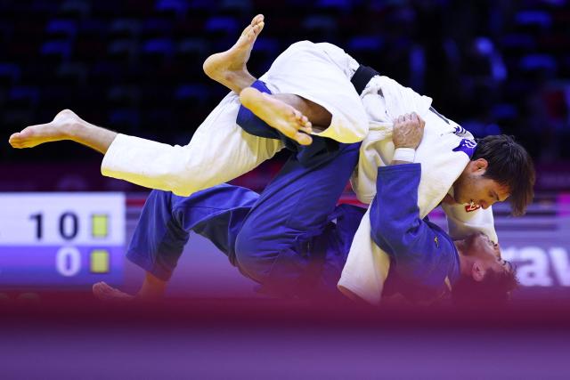 Italy's Manuel Parlati (white) competes against Moldova's Petru Pelivan in the men's under 81 kg round of 64 at the World Judo Championships in Baku on October 7, 2026. (Photo by Anne-Christine POUJOULAT / AFP)