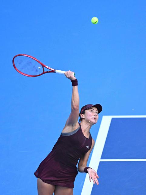 USA's Iva Jovic serves to Poland's Iga Swiatek during their women's singles match at the China Open tennis tournament in Beijing on October 7, 2026. (Photo by Adek BERRY / AFP)