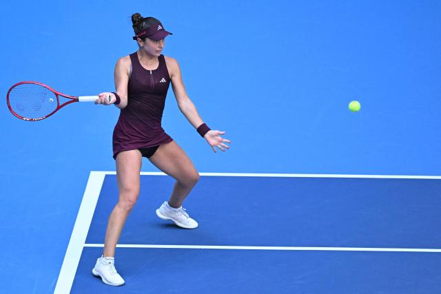 USA's Iva Jovic hits a return against Poland's Iga Swiatek during their women's singles match at the China Open tennis tournament in Beijing on October 7, 2026. (Photo by Adek BERRY / AFP)
