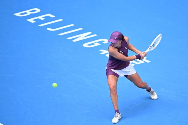 Poland’s Iga Swiatek hits a shot to USAґs Iva Jovic during their women's singles match at the China Open tennis tournament in Beijing on October 7, 2026. (Photo by Adek BERRY / AFP)