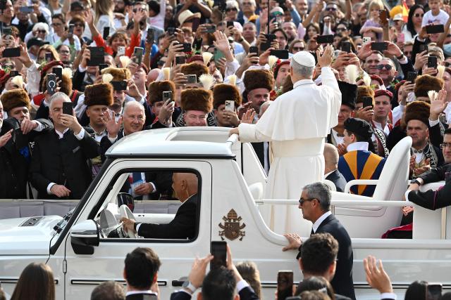 Pope Leo XIV waves to the crowd from the popemobile as he arrives for the weekly general audience at St Peter's Square, in the Vatican, on October 7, 2026. (Photo by Andreas SOLARO / AFP)