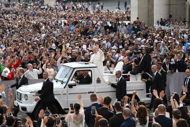 Pope Leo XIV (C) waves from his Papamobile to the crowd during the weekly general audience at St Peter's Square in the Vatican on October 7, 2026. (Photo by Andreas SOLARO / AFP)
